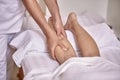 Two people, man physiotherapist leg massage, hands close up. Royalty Free Stock Photo