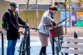 Two People Man And Woman Unlocking And Preparing To Leave Their Destination Using Bicycles
