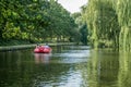 People On A Pedal Boat Sailing On A River In The Munke Mose Park, Odense, Denmark