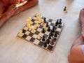 Two people playing chess on an old cardboard board Royalty Free Stock Photo