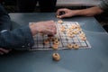 Two people playing Chinese Chess, close-up Royalty Free Stock Photo