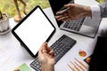 Two people pointing at a blank tablet screen, two businessmen meeting to discuss joint venture business, they are looking at Royalty Free Stock Photo