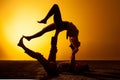 Two people practicing yoga in the sunset light Royalty Free Stock Photo