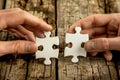 Two people putting two puzzle pieces together - concept image created by CNC machine