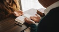 Two people reading and study bible in home and pray together.Studying the Word Of God Royalty Free Stock Photo