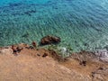 Two people rest in the Red Sea in Sharm El Sheikh Egypt, aerial view. Yellow-orange beach, a rock in the sea, clear blue- Royalty Free Stock Photo