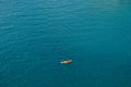 Two people row oars in one yellow-red kayak against the texture of the sea. Concept banner travel. Aerial top view. Royalty Free Stock Photo