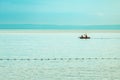 Two people rowing a inflatable dinghy boat at Kvarner gulf of Adriatic sea in summer morning. Active vacation lifestyle concept Royalty Free Stock Photo