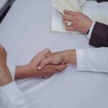 Two people are shaking hands against Royalty Free Stock Photo