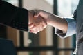 Two people shaking hands in a business setting