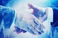 Two people shaking hands, graphs Royalty Free Stock Photo