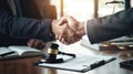 lawyer shaking hands to seal a deal with client after signing contract