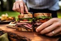 two people sharing a rye bread sandwich Royalty Free Stock Photo