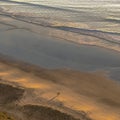 Two people silhouetted by sunset at Blacks Beach