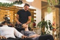 Two people sit on shampoo chairs in hairdresser salon. Pregnant woman having her blond hair washed by a professional Royalty Free Stock Photo