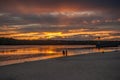 Two people are sitting on the bank