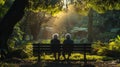 Two People Sitting on a Bench in a Park Royalty Free Stock Photo