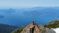 two people standing on a large mountain on a clear day