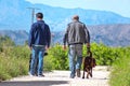 Two people taking their dogs for a walk after the national lockdown becuase of the coronavirus or COVID-19 spreading in Spain