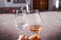 Two people toasting each other outdoors with two glasses of wine, rose and white Royalty Free Stock Photo