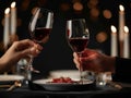 Two people toasting wine glasses at a dinner table Royalty Free Stock Photo