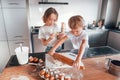 Two people together. Little boy and girl preparing Christmas cookies on the kitchen Royalty Free Stock Photo