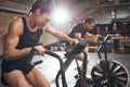 Two people training in effort on simulators Royalty Free Stock Photo