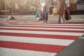 Two people walking across the road on the pedestrian crossing Royalty Free Stock Photo