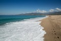 Two people walking along the beach at Sagone in Corsica