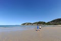 Two people walking on the beautiful sandy beach at Florence Bay, Magnetic Island, QLD, Australia