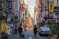 Two people walking at a street in Seoul