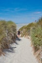 Two people are walking to the surfer beach called: Pointe de la Torche Royalty Free Stock Photo