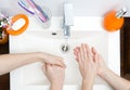 Two people wash their hands with soap under running water in white sink. close - up. antivirus protection wash your Royalty Free Stock Photo