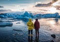 Two people watching on floating icebergs in Jokulsarlon glacier lagoon Royalty Free Stock Photo