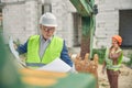 Two people working at a building site