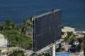 Two people are working on a huge empty billboard. Mancora, Peru