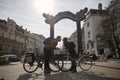 Two people, 20-29 years old, romantic couple looking at each other head to head, while posing, leaning with their bicycles. Royalty Free Stock Photo