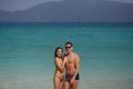 Two perfect bodies person posing on sea background. Male and female Royalty Free Stock Photo