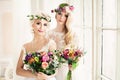 Two Perfect Bride. Blonde Women with Flower Arrangement Royalty Free Stock Photo