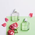 Two perfume bottles and rose flowers on green and white background. Beauty, fashion concept. Top view, flat lay, mockup Royalty Free Stock Photo