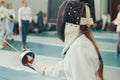 Two person fencers having fencing duel on tournament