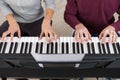 Two person playing keyboards Royalty Free Stock Photo