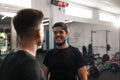 Two personal trainers smiling at each other at the gym Royalty Free Stock Photo