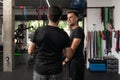 Two personal trainers talking to each other at the gym Royalty Free Stock Photo