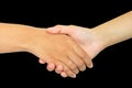 Two persons shaking hands on black background Royalty Free Stock Photo