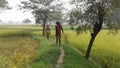 Two persons walking inside field Royalty Free Stock Photo