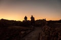 Two horse riders during sunrise