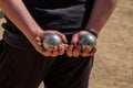 Two petanque boules in the hands of a player Royalty Free Stock Photo