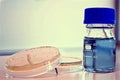 Two petri dishes and a bottle Royalty Free Stock Photo