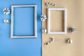 Two photo frames and Christmas decoration on color geometric background. Royalty Free Stock Photo